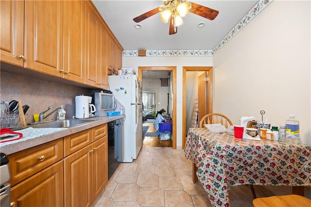 kitchen with sink, dishwasher, ceiling fan, white refrigerator, and tasteful backsplash