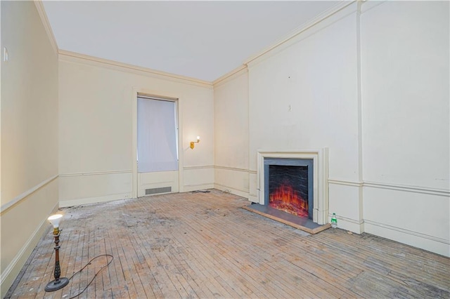 unfurnished living room with crown molding and wood-type flooring