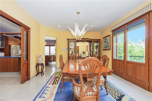 dining room featuring baseboards, a notable chandelier, and recessed lighting