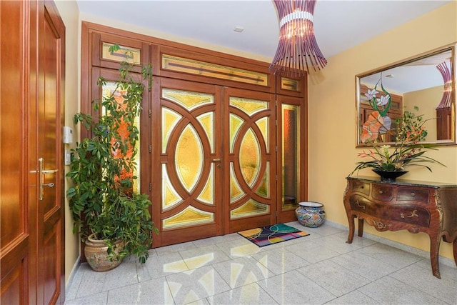 entryway with baseboards and light speckled floor