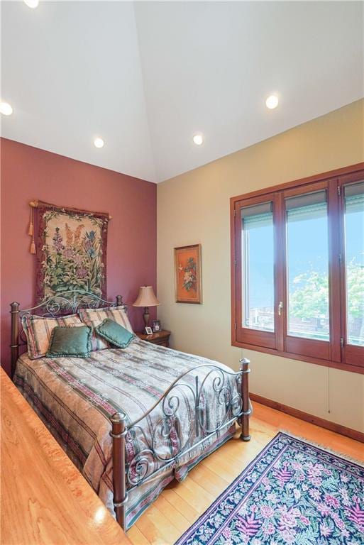 bedroom featuring recessed lighting, vaulted ceiling, baseboards, and wood finished floors