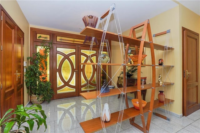 interior space featuring granite finish floor and baseboards