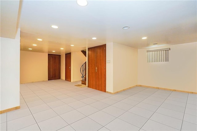 empty room with light tile patterned floors, baseboards, stairway, and recessed lighting