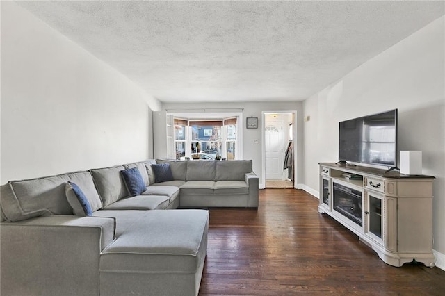 living room with dark wood-type flooring and a textured ceiling