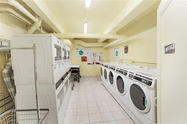 community laundry room with stacked washer and dryer, light tile patterned flooring, and independent washer and dryer