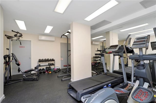 workout area with an AC wall unit and a wall mounted AC