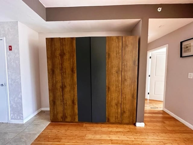 interior space featuring light wood-type flooring and baseboards