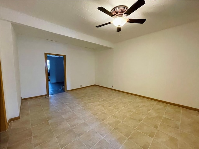 tiled empty room featuring ceiling fan