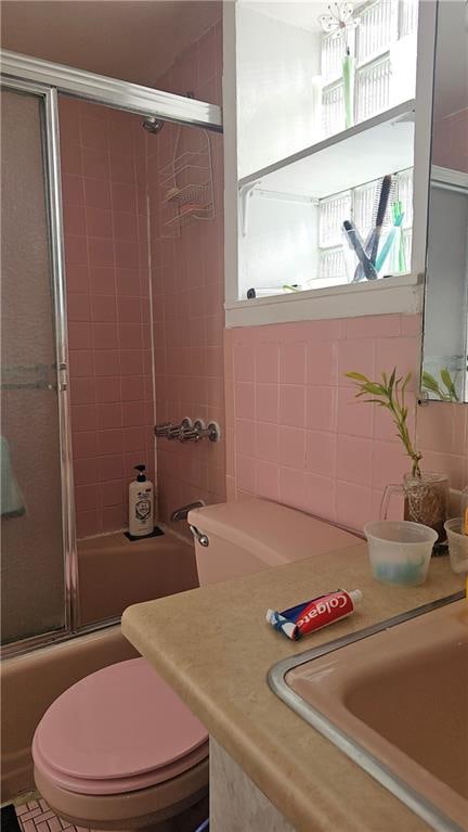 full bathroom with tasteful backsplash, vanity, enclosed tub / shower combo, and toilet