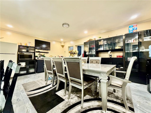 dining space with ornamental molding