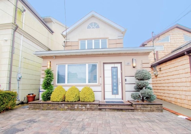 view of exterior entry with stucco siding