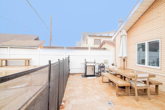 view of patio / terrace with grilling area, outdoor dining area, and a fenced backyard