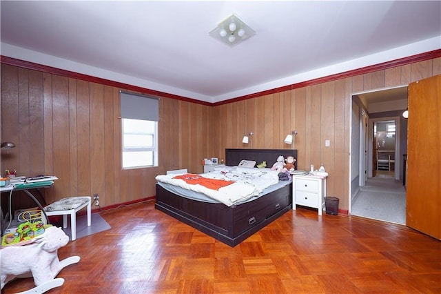 bedroom with parquet flooring and wood walls