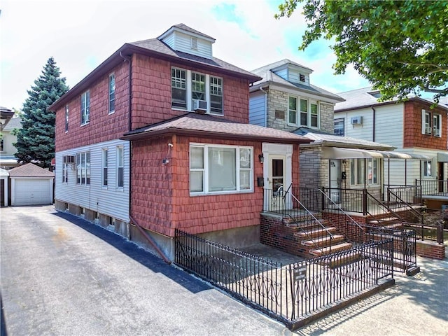 view of front of home featuring a garage and an outdoor structure