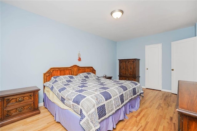 bedroom with baseboards and wood finished floors