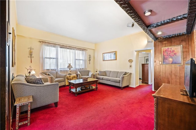 living room featuring carpet floors and wood walls