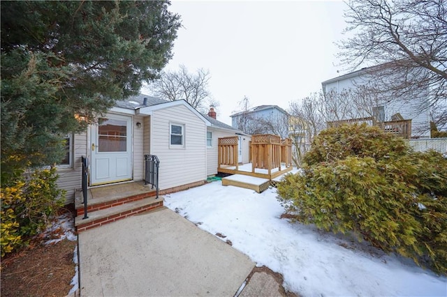 exterior space featuring a chimney and a deck