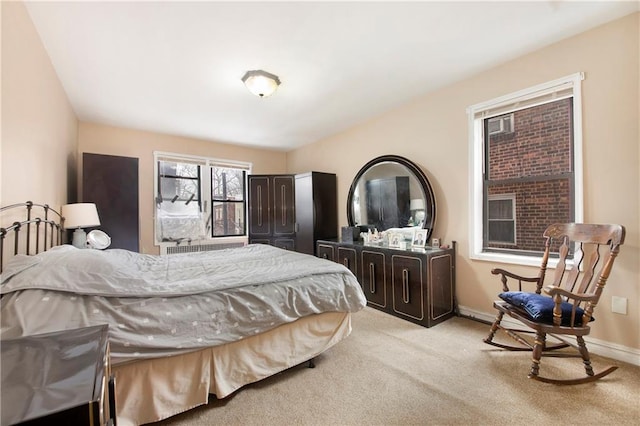 bedroom with baseboards and light colored carpet