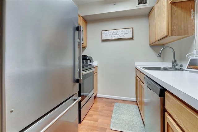 260 Bch 81st St Unit 4M, Rockaway Beach, NY 11693 - kitchen with appliances with stainless steel finishes, a sink, light wood-style flooring, light brown cabinetry, and light countertops