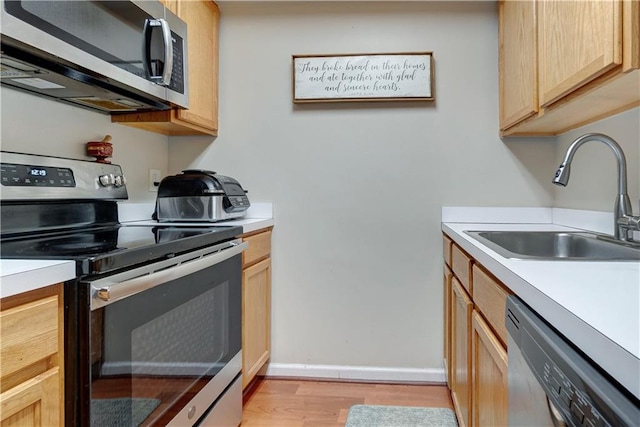 260 Bch 81st St Unit 4M, Rockaway Beach, NY 11693 - kitchen with stainless steel appliances, a sink, light wood finished floors, and light brown cabinets