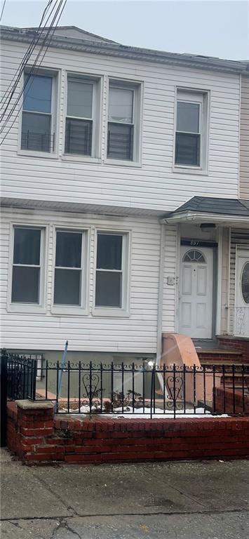 view of front of home featuring fence