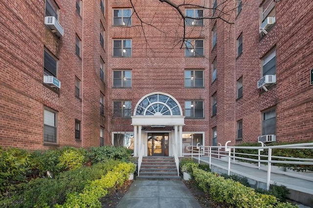 view of building exterior featuring fence and cooling unit