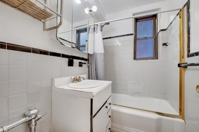 full bathroom featuring shower / bath combo, tile walls, and vanity