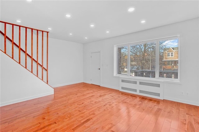 interior space featuring stairs, baseboards, light wood-style flooring, and recessed lighting