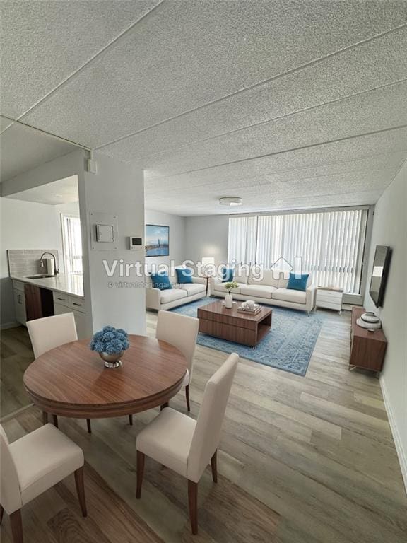 dining room with sink and light hardwood / wood-style flooring