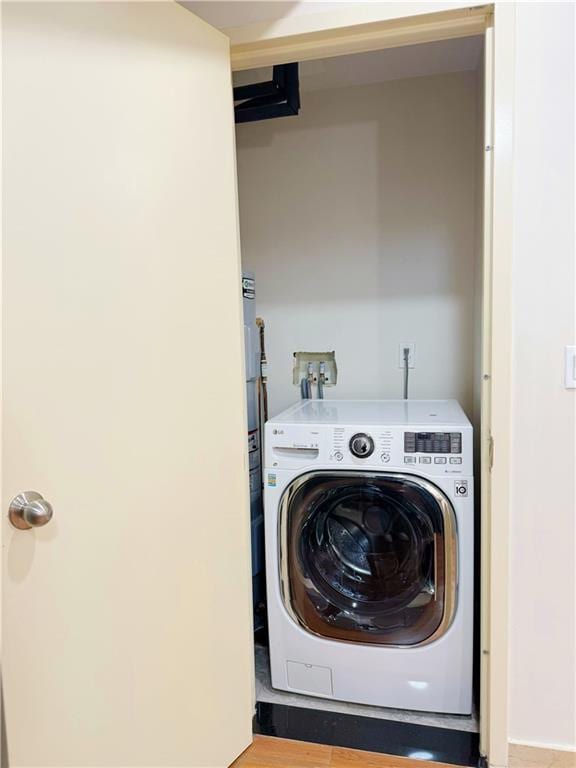 clothes washing area with washer / dryer