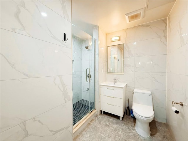42-22 Crescent St Unit 2C, Long Island City, NY 11101 - bathroom with a marble finish shower, vanity, marble look tile flooring, and tile walls