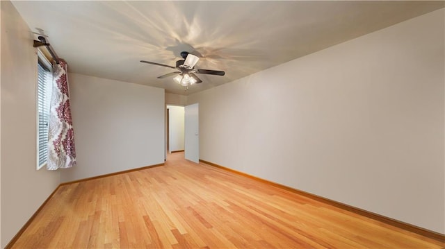 spare room featuring ceiling fan and light hardwood / wood-style flooring