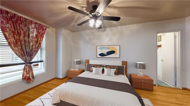 bedroom with wood-type flooring and ceiling fan