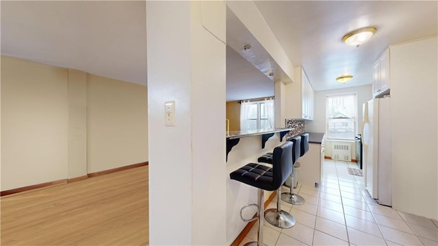 hall with radiator and light hardwood / wood-style floors