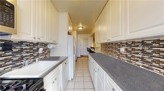 kitchen with white cabinetry, white appliances, decorative backsplash, and light tile patterned flooring