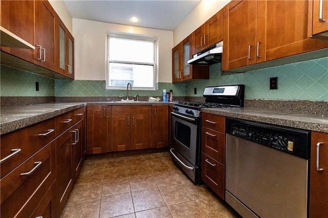 kitchen featuring sink, backsplash, stainless steel appliances, and dark tile patterned floors