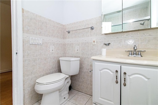 bathroom with vanity, tile walls, and toilet