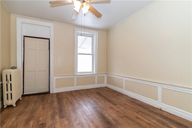 unfurnished bedroom featuring radiator, crown molding, dark wood-type flooring, and ceiling fan