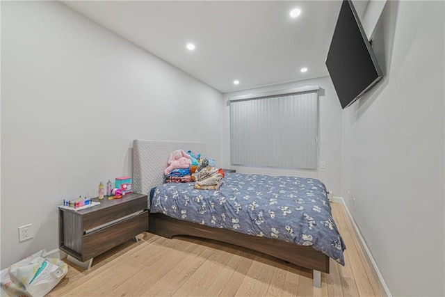 bedroom with hardwood / wood-style floors