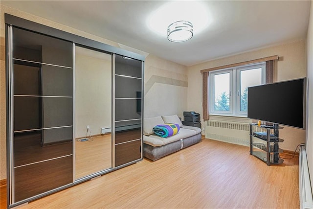 interior space featuring wood-type flooring and baseboard heating