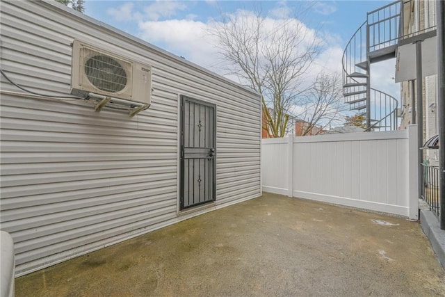 view of exterior entry with ac unit and a patio area