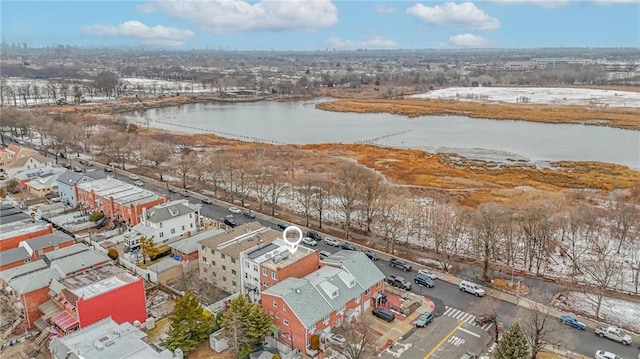 snowy aerial view with a water view