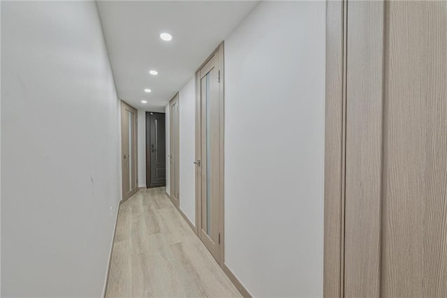 hallway with light hardwood / wood-style flooring