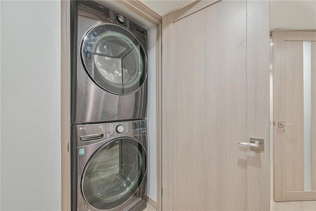 laundry room with stacked washer and clothes dryer