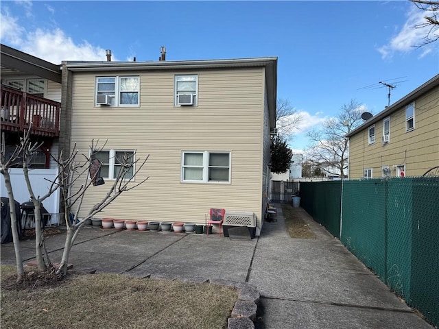 rear view of house with a patio area and a fenced backyard