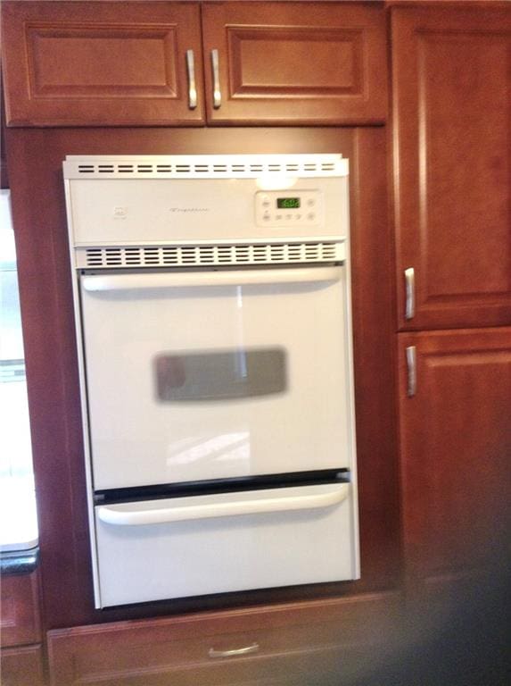 details featuring brown cabinets and white double oven