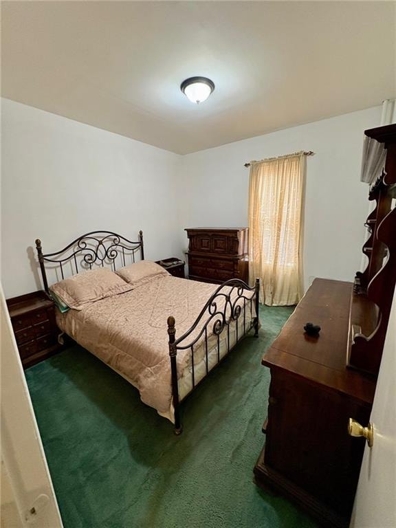 bedroom featuring dark colored carpet