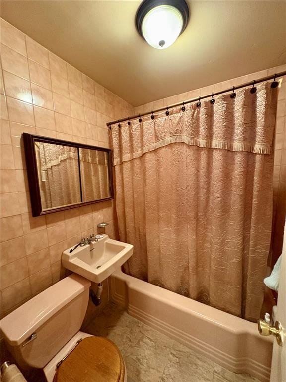 full bathroom featuring tile walls, sink, shower / bath combination with curtain, and toilet