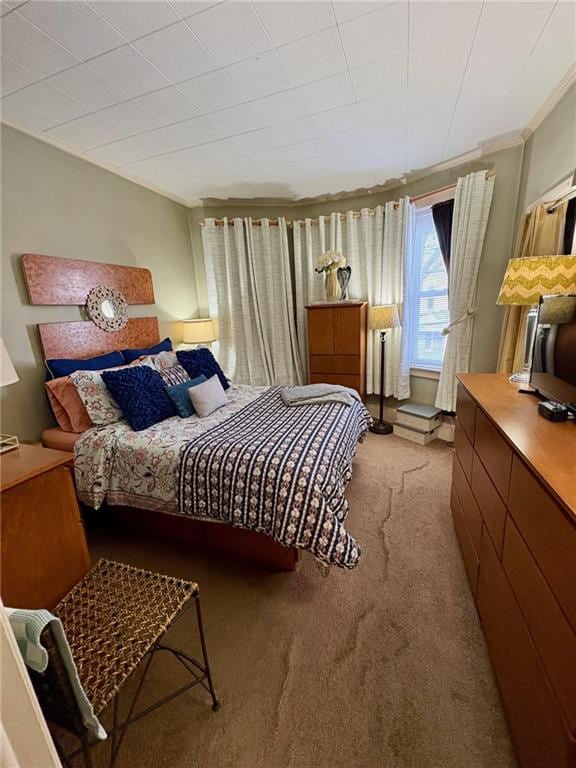 carpeted bedroom featuring crown molding