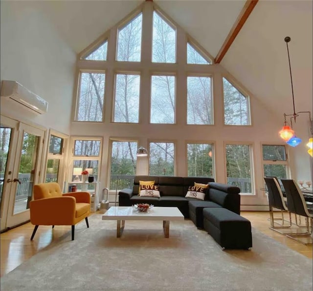 sunroom / solarium with a wall unit AC, a chandelier, and french doors